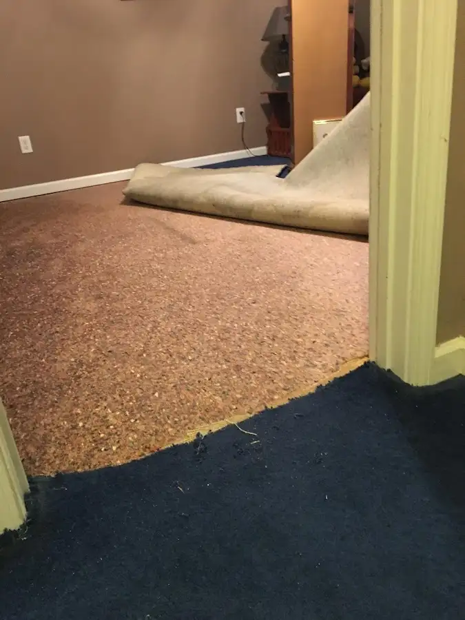 Carpet pad removal revealing water damage during Water Mitigation Services in Hillcrest Heights